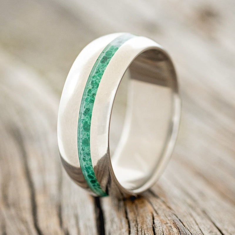 Shown here is "Vertigo", a custom, handcrafted men's domed wedding ring featuring an offset malachite inlay, upright facing left. Additional inlay options are available upon request.