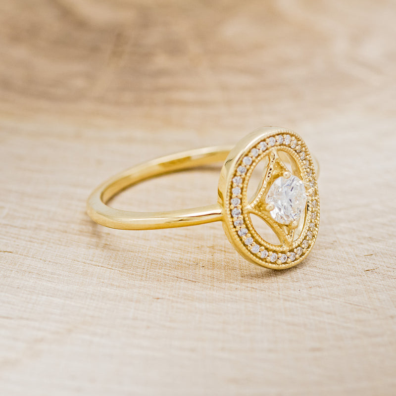 Shown here is "Levina", a diamond women's engagement ring with a diamond halo, facing right. Many other center stone options are available upon request.