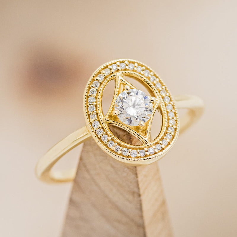 Shown here is "Levina", a diamond women's engagement ring with a diamond halo, on stand facing slightly right. Many other center stone options are available upon request. 