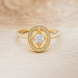Shown here is "Levina", a diamond women's engagement ring with a diamond halo, front facing. Many other center stone options are available upon request.