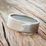 Shown here is a custom, handcrafted men's wedding ring featuring a hand-turned Damascus Steel wedding band lined with diamond dust, tilted left. Additional inlay options are available upon request.