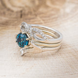 Shown here is Claddagh bridal suite, a solitaire-style lab-created alexandrite women's engagement ring with a diamond accent tracer and a Claddagh tracer, facing left. Many other center stone options are available upon request.