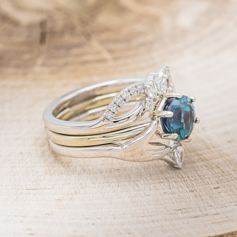 Shown here is Claddagh bridal suite, a solitaire-style lab-created alexandrite women's engagement ring with a diamond accent tracer and a Claddagh tracer, facing right. Many other center stone options are available upon request.