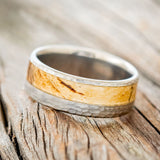 "Tanner" is a custom, handcrafted men's wedding ring featuring a spalted maple wood inlay with a hammered band, tilted left. Additional inlay options are available upon request.