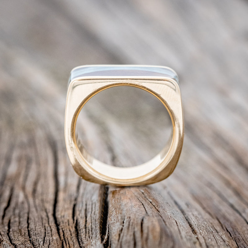 Shown here is "Mesa", a custom, handcrafted men's wedding band featuring a flat top 14K gold band with ironwood and turquoise inlays, upright side view. Additional inlay options are available upon request.