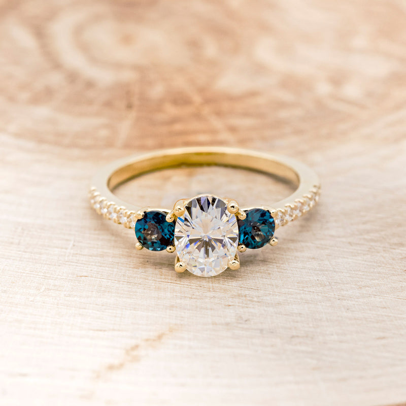 Shown here is "Cosette", a moissanite and lab-created alexandrite women's engagement ring with diamond accents, front facing. many center stone options are available upon request.