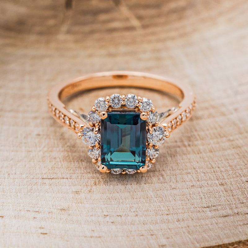 Shown here is "Ophelia", a lab-created alexandrite women's engagement ring with a diamond halo and diamond accents, front facing. Many other center stone options are available upon request.