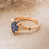Shown here is "Annora", an accented-style lab-created alexandrite women's engagement ring with diamond and black diamond accents, facing left. Many other center stone options and shapes are available upon request.