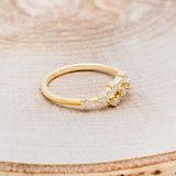 Shown here is "Zodiac", a custom, handcrafted women's stacker featuring a Cancer constellation on a 14K gold band, facing right. People born between the dates of June 21st – July 22nd are a Cancer.