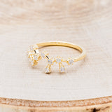 Shown here is "Zodiac", a custom, handcrafted women's stacker featuring a Sagittarius constellation on a 14K gold band, facing left. People born between the dates of November 22nd – December 21st are a Sagittarius.