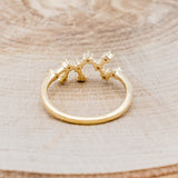 Shown here is "Zodiac", a custom, handcrafted women's stacker featuring a Sagittarius constellation on a 14K gold band, back view. People born between the dates of November 22nd – December 21st are a Sagittarius.