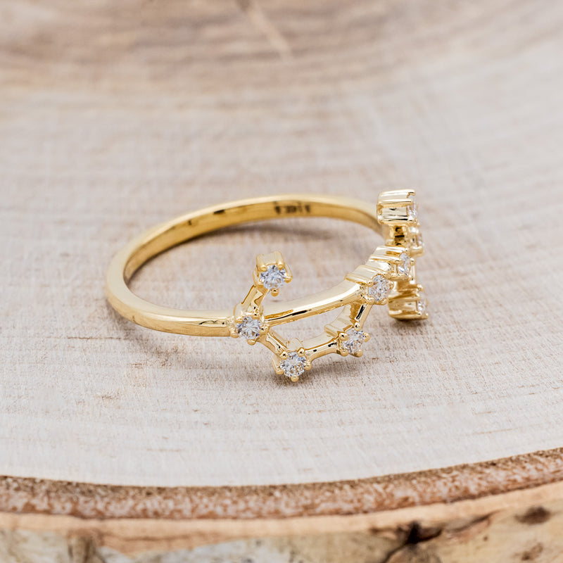 Shown here is "Zodiac", a custom, handcrafted women's stacker featuring a Scorpio constellation on a 14K gold band, facing right. People born between the dates of October 23rd – November 21st are a Scorpio.