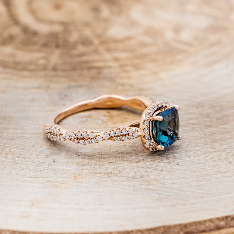 Shown here is "Kinley", a lab-created alexandrite women's engagement ring with a diamond halo and diamond accents, facing right. Many other center stone options are available upon request.
