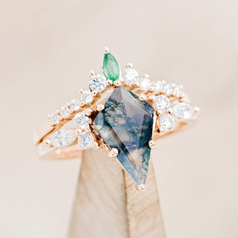 Shown here is "Sage", a moss agate women's engagement ring with diamond accents and an emerald tracer, on stand tilted right. Many other center stone options are available upon request. 