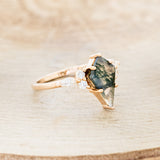 Shown here is "Sage", a moss agate women's engagement ring with diamond accents, facing right. Many other center stone options are available upon request.