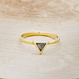 Shown here is "Mera", a triangle-style women's stacking band featuring a triangle channel filled with black fire opal on a 14K gold band, front facing. Many center stone options are available upon request.