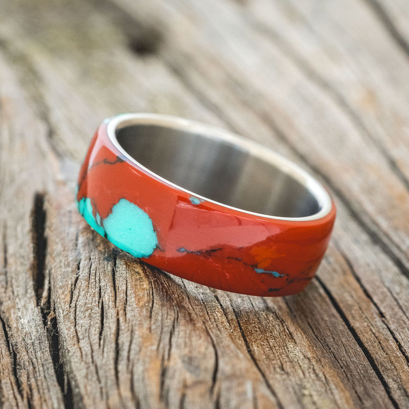 Shown here is "Haven", a custom, handcrafted men's wedding ring featuring a Sonora sunset TruStone overlay on a titanium band, tilted left. Additional overlay options are available upon request.