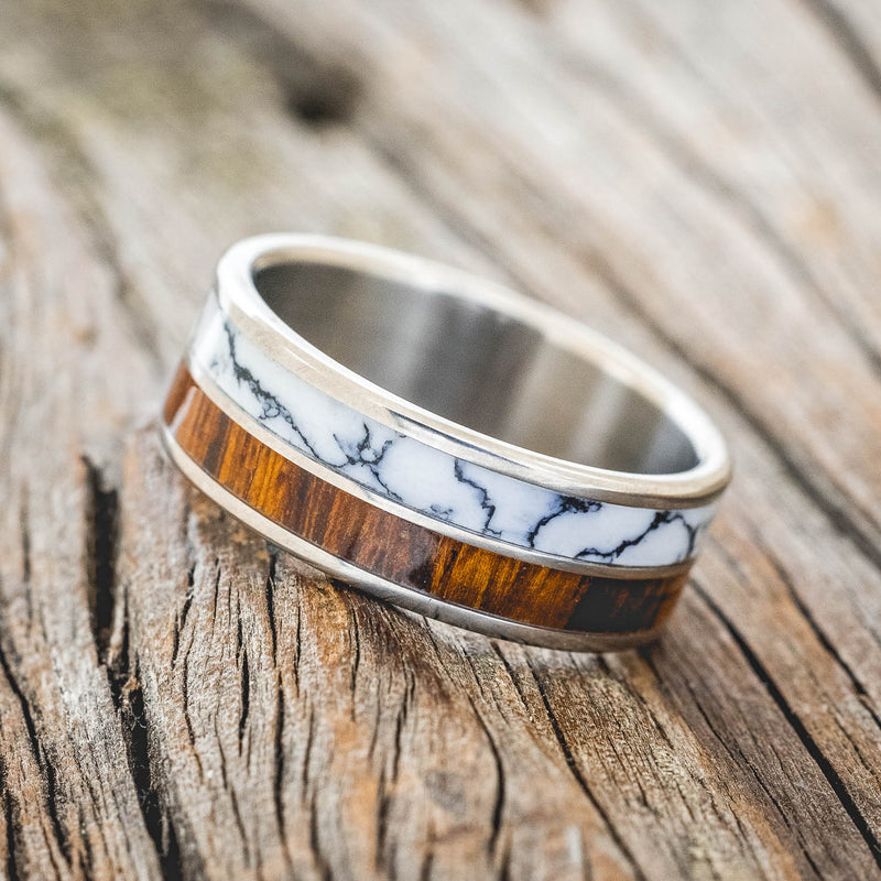 Shown here is "Dyad", a custom, handcrafted men's wedding ring featuring 2 channels with ironwood and white turquoise TruStone inlays, tilted left. Additional inlay options are available upon request.