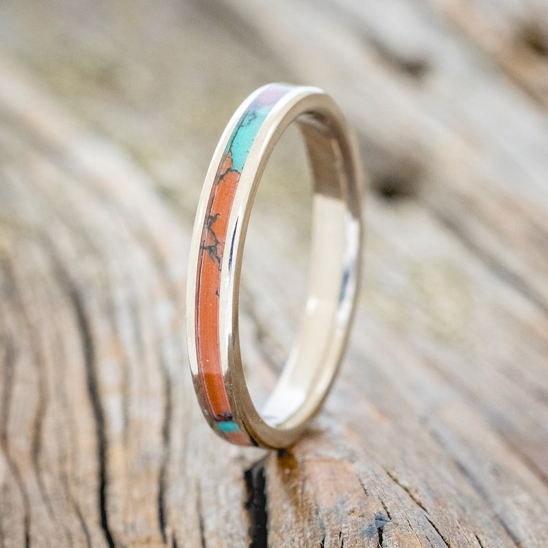 Shown here is "Eterna", a custom, handcrafted wedding ring featuring Sonora sunset TruStone inlay on a titanium band, upright facing left. Additional inlay options are available upon request.