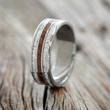 Shown here is "Rio", a custom, handcrafted men's wedding ring featuring 3 channels with ironwood and antler inlays, upright facing left. Additional inlay options are available upon request.