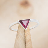 Shown here is "Jenny From The Block", a dainty-style triangle lab-created ruby women's engagement ring, on stand front facing. Many other center stone options are available upon request.