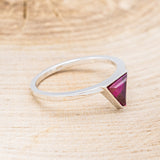 Shown here is "Jenny From The Block", a dainty-style triangle lab-created ruby women's engagement ring, facing right. Many other center stone options are available upon request.