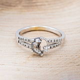 Shown here is "Nyx", a crescent moon salt & pepper diamond women's engagement ring with a single diamond accent and a diamond accented band, front facing. Many other center stone option are available upon request.