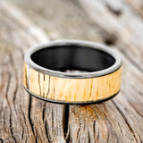 Shown here is "Rainier", a custom, handcrafted men's wedding ring featuring spalted maple wood inlay, laying flat. Additional inlay options are available upon request.