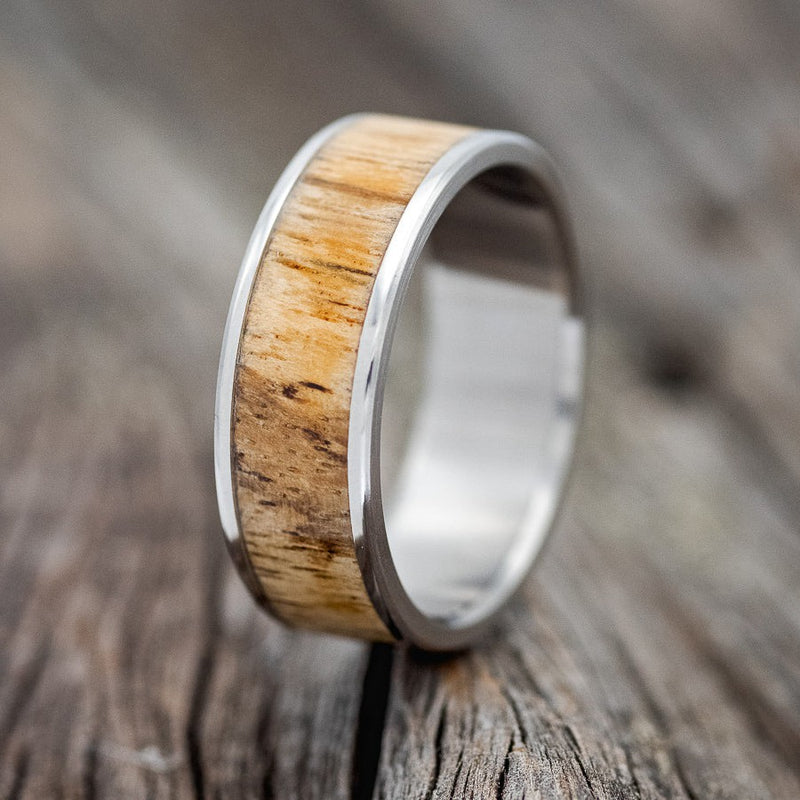 Shown here is "Rainier", a custom, handcrafted men's wedding ring featuring spalted maple wood inlay, upright facing left. Additional inlay options are available upon request.