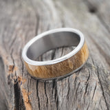 Shown here is "Rainier", a custom, handcrafted men's wedding ring featuring spalted maple wood inlay, tilted right. Additional inlay options are available upon request.