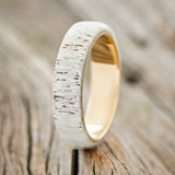 Shown here is "Haven", a custom, handcrafted men's wedding ring featuring an antler overlay, upright facing left. Additional overlay options are available upon request.
