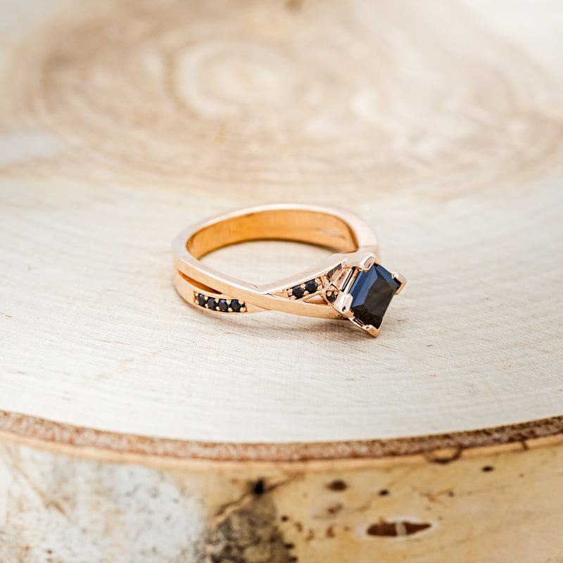 Shown here is "Lina", a black moissanite women's engagement ring with black diamond accents, facing right. Many other center stone options are available upon request.
