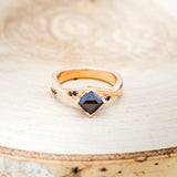Shown here is "Lina", a black moissanite women's engagement ring with black diamond accents, front facing. Many other center stone options are available upon request.