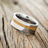 Shown here is "Vertigo", a custom, handcrafted men's wedding ring featuring a whiskey barrel inlay, tilted left. Additional inlay options are available upon request.