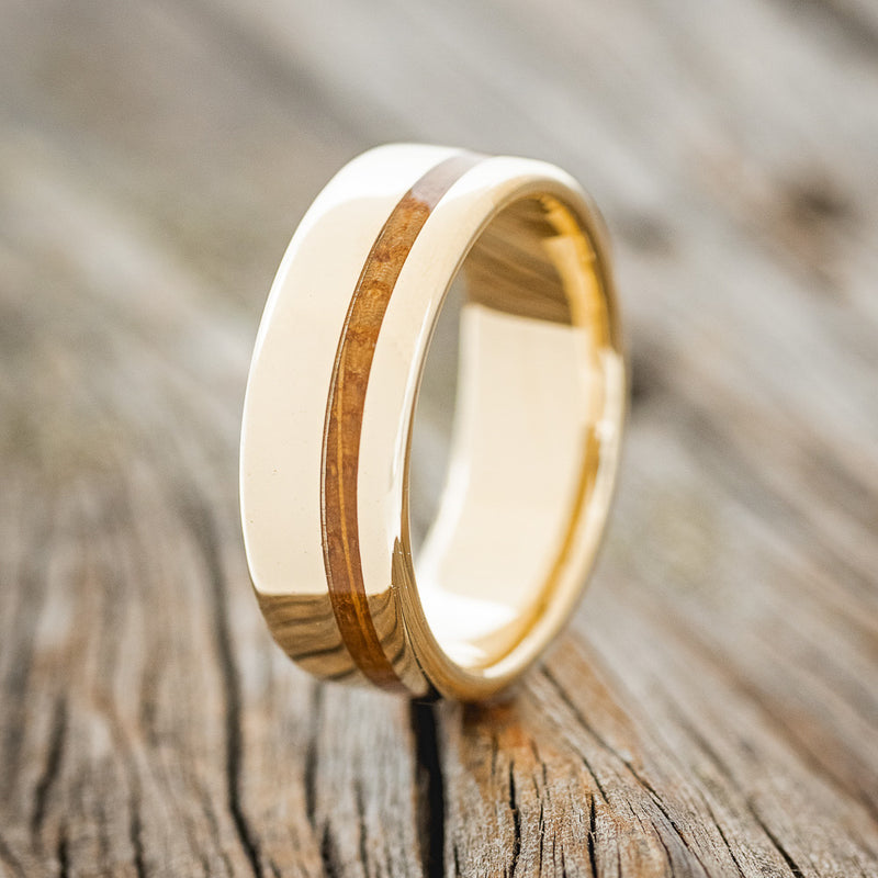 Shown here is "Vertigo", a custom, handcrafted men's wedding ring featuring a whiskey barrel inlay, upright facing left. Additional inlay options are available upon request.
