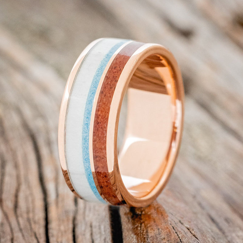 Shown here is "Element", a custom, handcrafted men's wedding ring featuring 2 channels with elk antler, turquoise, and Texas Mesquite wood inlays, upright facing left. Additional inlay options are available upon request.