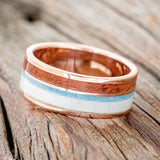 Shown here is "Element", a custom, handcrafted men's wedding ring featuring 2 channels with elk antler, turquoise, and Texas Mesquite wood inlays, tilted left. Additional inlay options are available upon request.