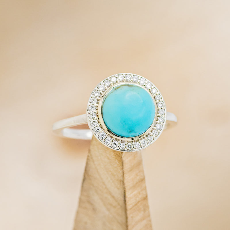 Shown here is The "Terra" is a turquoise women's engagement ring with a diamond halo