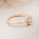 Shown here is "Starla", a champagne diamond women's engagement ring with a starburst diamond halo, facing right. Many other center stone options are available upon request.