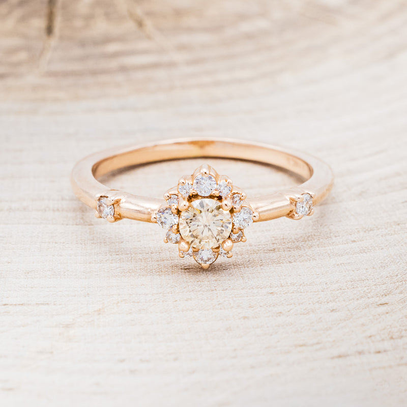 Shown here is "Starla", a champagne diamond women's engagement ring with a starburst diamond halo, front facing. Many other center stone options are available upon request.