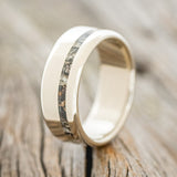 Shown here is "Vertigo", a custom, handcrafted men's wedding ring featuring an offset camo inlay, upright facing left. Additional inlay options are available upon request.
