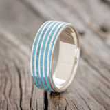 Shown here is a custom, handcrafted men's wedding ring featuring a threaded pattern with turquoise inlays, upright facing left. Additional inlay options are available upon request.