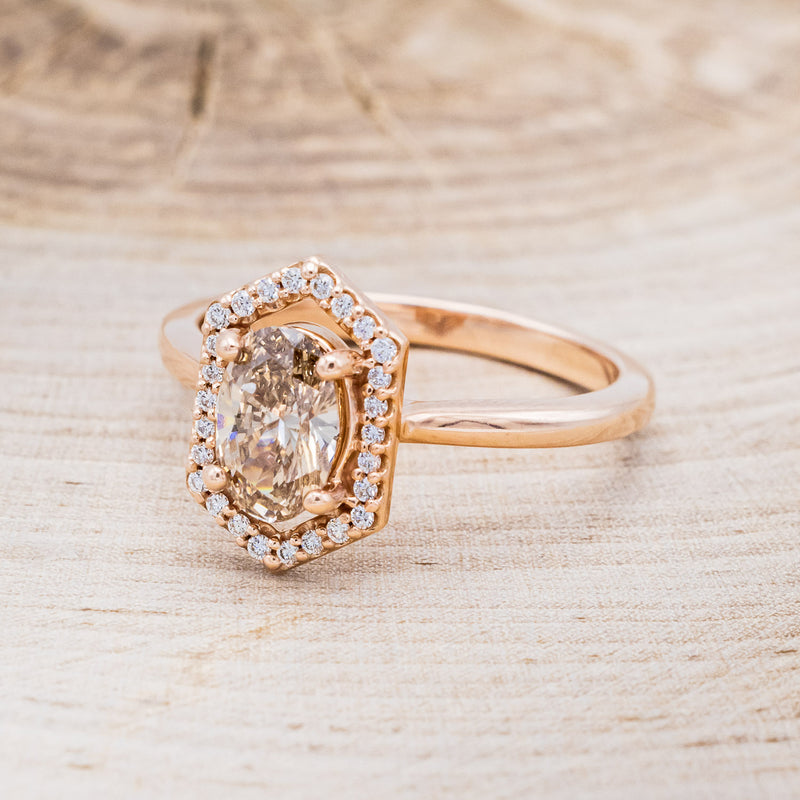 Shown here is a one-of-a-kind champagne diamond women's engagement ring with a geometric diamond halo, facing left. Many other center stone options are available upon request.