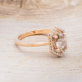 Shown here is a one-of-a-kind champagne diamond women's engagement ring with a geometric diamond halo, facing right. Many other center stone options are available upon request.