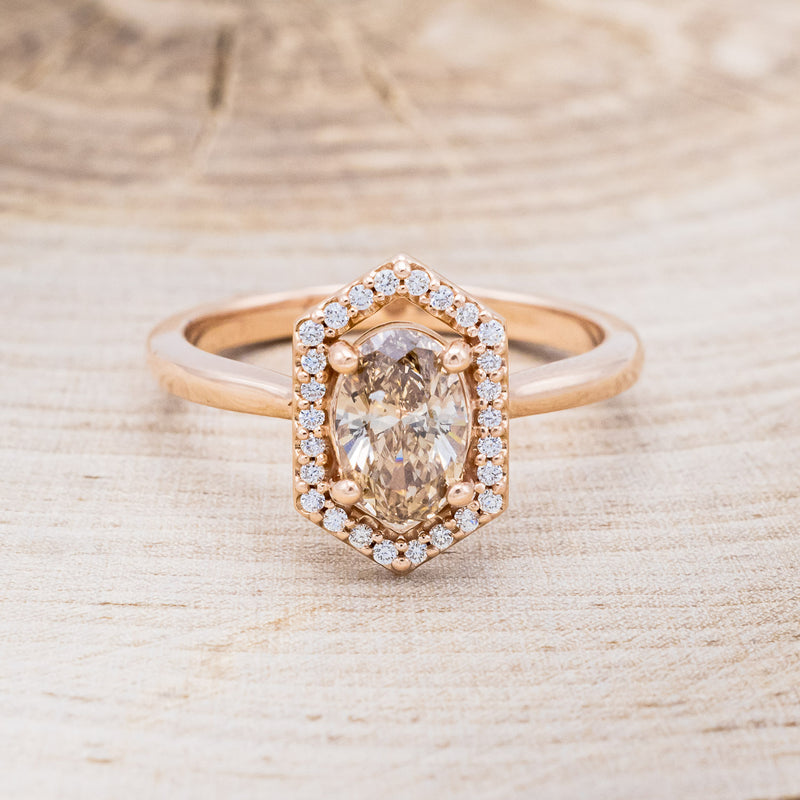 Shown here is a one-of-a-kind champagne diamond women's engagement ring with a geometric diamond halo, front facing. Many other center stone options are available upon request.