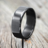 Shown here is a handcrafted men's wedding ring featuring a solid fire-treated black zirconium band, upright facing left. Additional inlay options are available upon request.