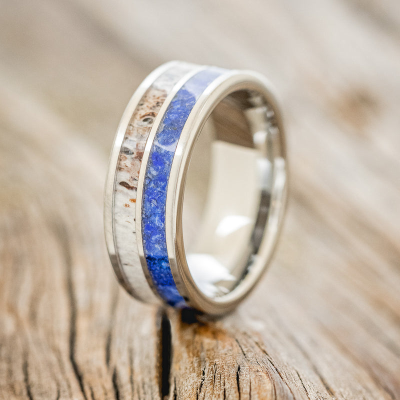 Shown here is "Dyad", a custom, handcrafted men's wedding ring featuring 2 channels with lapis lazuli and antler inlays, upright facing left.