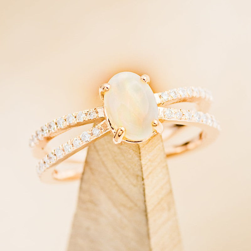 Shown here is a split shank-style opal women's engagement ring with diamond accents, on stand facing slightly right. Many other center stone options are available upon request.