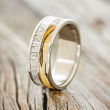 Shown here is "Dyad", a custom, handcrafted men's wedding ring featuring 2 channels with spalted maple and antler inlays, shown here on a titanium band, upright facing left. Additional inlay options are available upon request.