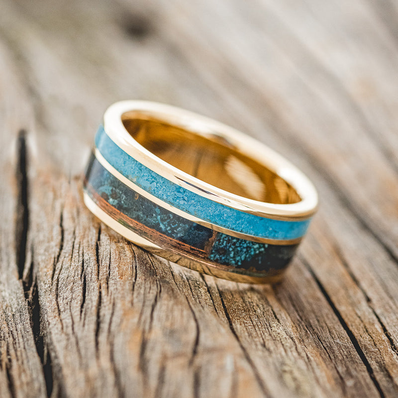 Shown here is "Raptor", a custom, handcrafted men's wedding ring featuring a patina copper and turquoise inlay, tilted left. Additional inlay options are available upon request.